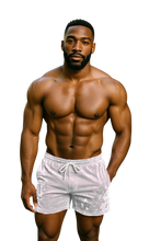 Load image into Gallery viewer, Muscular man wearing white velvet shorts with pockets and drawstring 
