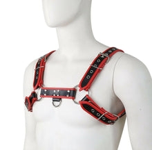 Load image into Gallery viewer, The image displays a striking black and red vinyl harness, designed for adult play. Featuring high-quality PU materials, the harness sports a bold red color with intricate black detailing and buckles.
